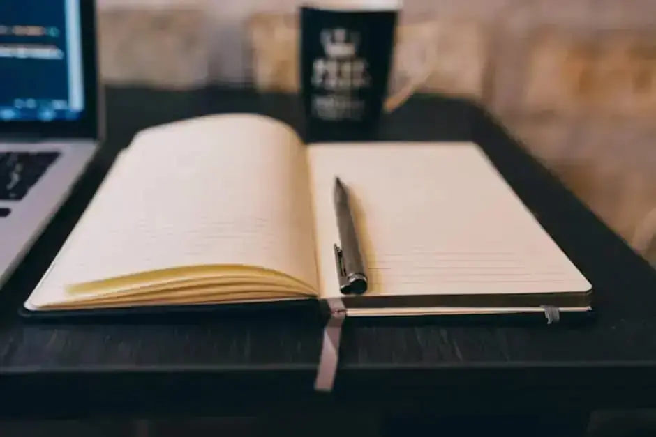 Clean B2B SaaS writer workstation with copybooks and coffee